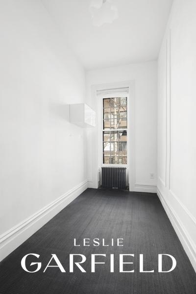 unfurnished room featuring radiator and baseboards