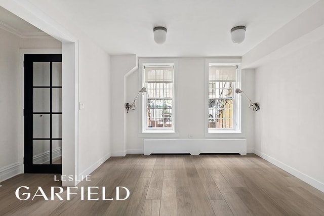 interior space featuring wood finished floors and baseboards