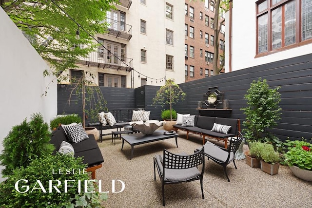 view of patio featuring fence and an outdoor hangout area