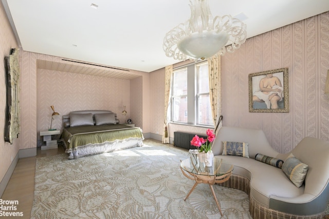 bedroom with radiator, wallpapered walls, baseboards, and light wood finished floors