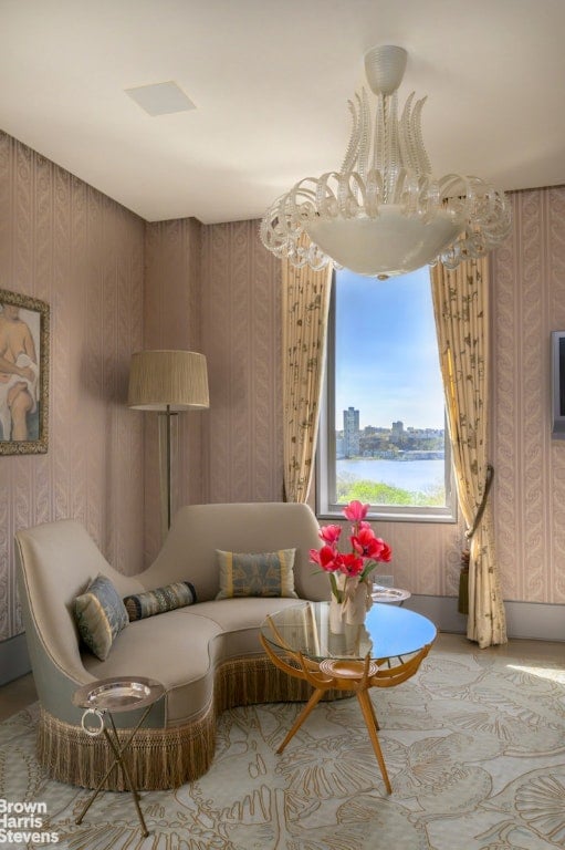 sitting room with a water view and wallpapered walls