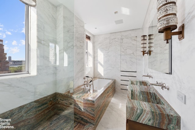 bathroom with a view of city, marble finish floor, tile walls, a bath, and stone wall