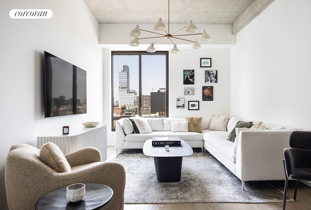 living room with visible vents, a notable chandelier, and wood finished floors