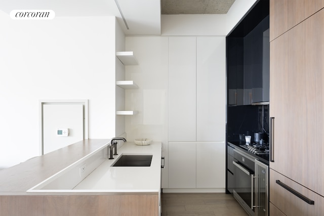 kitchen with modern cabinets, visible vents, open shelves, and a sink