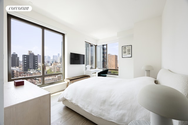 bedroom with visible vents and wood finished floors