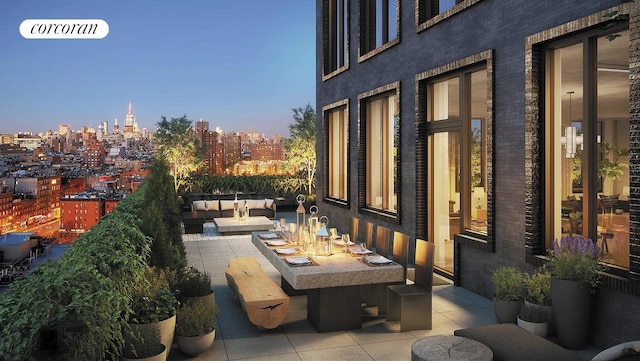 balcony featuring a patio, outdoor lounge area, and a city view