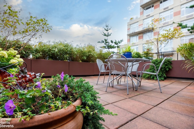 view of patio / terrace featuring outdoor dining space and fence