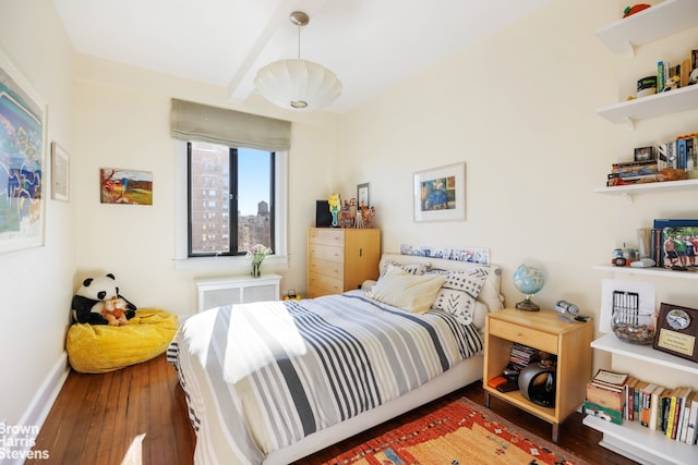 bedroom with beam ceiling, baseboards, and wood-type flooring