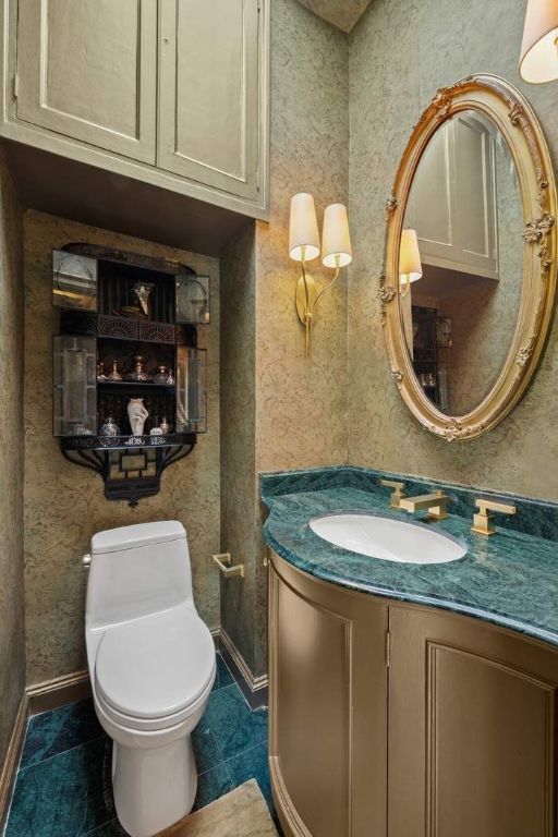 bathroom with tile patterned flooring, vanity, and toilet