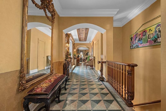 corridor with granite finish floor, arched walkways, and crown molding