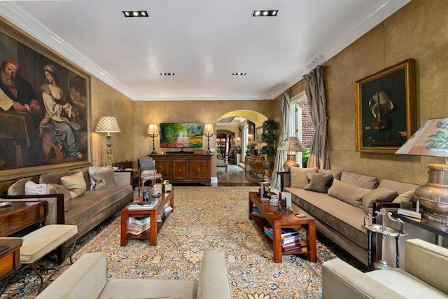 living room featuring ornamental molding and arched walkways