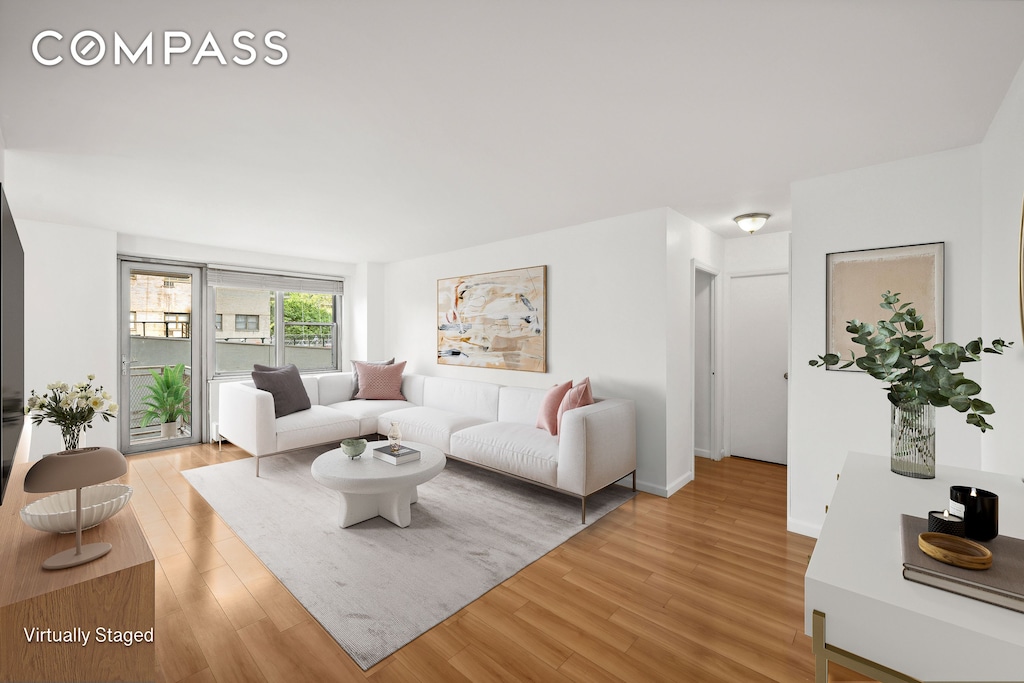 living area with light wood-style floors and baseboards