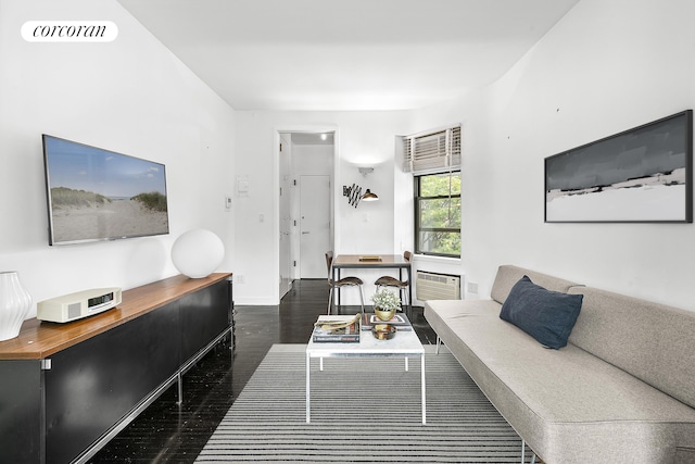 living room featuring baseboards, visible vents, and wood finished floors