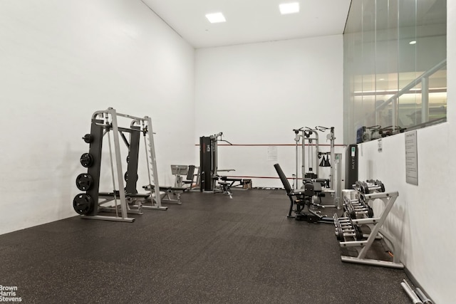 exercise room with a high ceiling