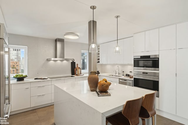 kitchen with sink, backsplash, wall chimney exhaust hood, and stainless steel appliances