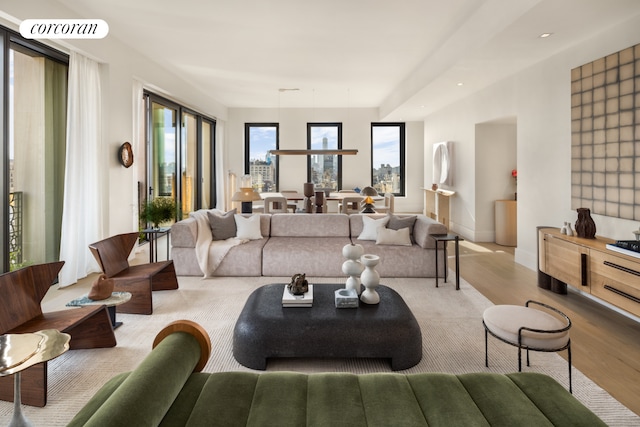 living area with visible vents, baseboards, and wood finished floors