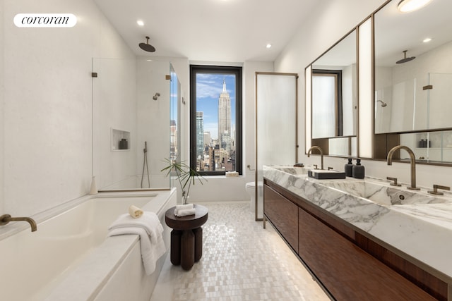 full bath featuring double vanity, visible vents, a bathing tub, a sink, and a walk in shower