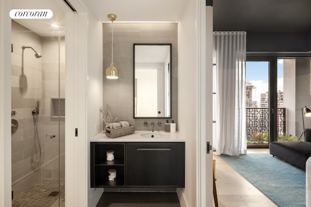 bathroom with a shower stall, visible vents, wood finished floors, and vanity