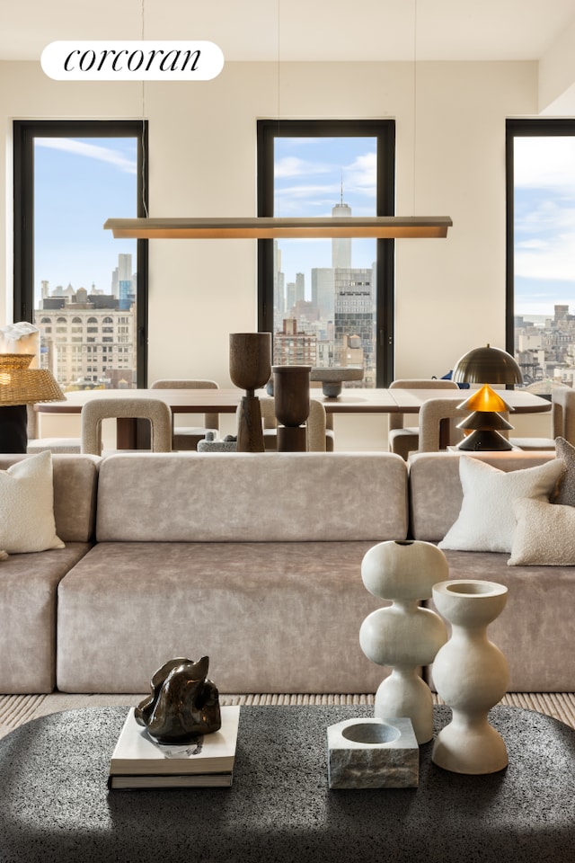 living area featuring a wealth of natural light and a city view