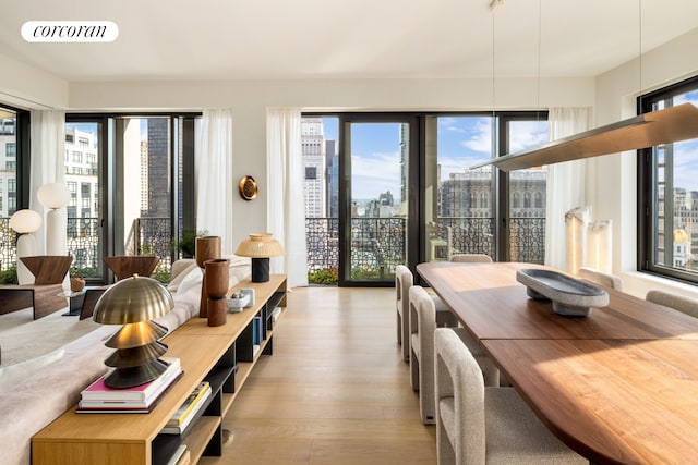 sunroom with a wealth of natural light, visible vents, and a city view