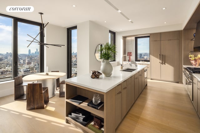 kitchen with a kitchen island with sink, visible vents, a sink, and modern cabinets