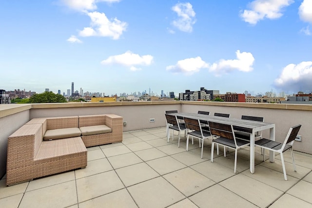 view of patio / terrace with an outdoor hangout area, a view of city, and outdoor dining space