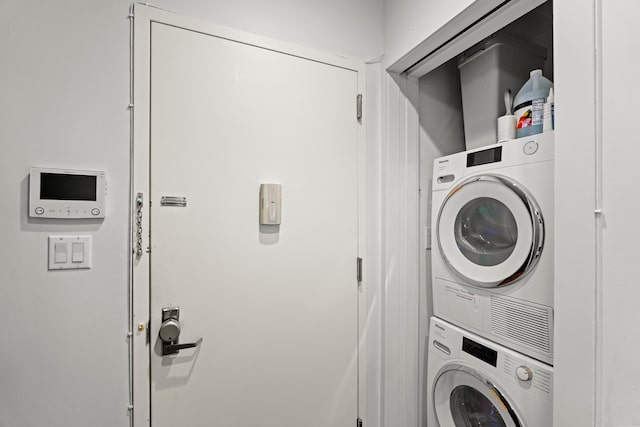clothes washing area featuring laundry area and stacked washer / dryer