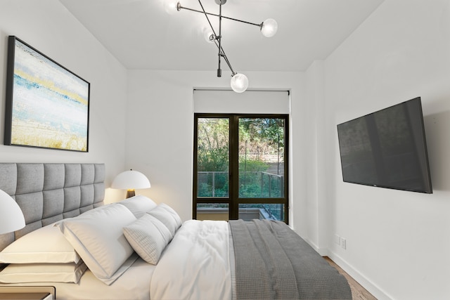 bedroom featuring baseboards and wood finished floors