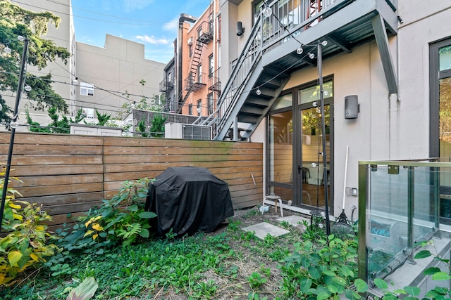 exterior space featuring fence and stucco siding