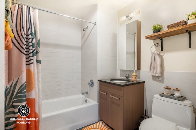 full bathroom with toilet, a wainscoted wall, tile walls, vanity, and shower / bathtub combination with curtain