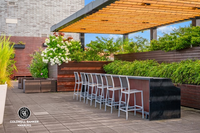 view of patio / terrace featuring an outdoor hangout area, outdoor dry bar, and a pergola