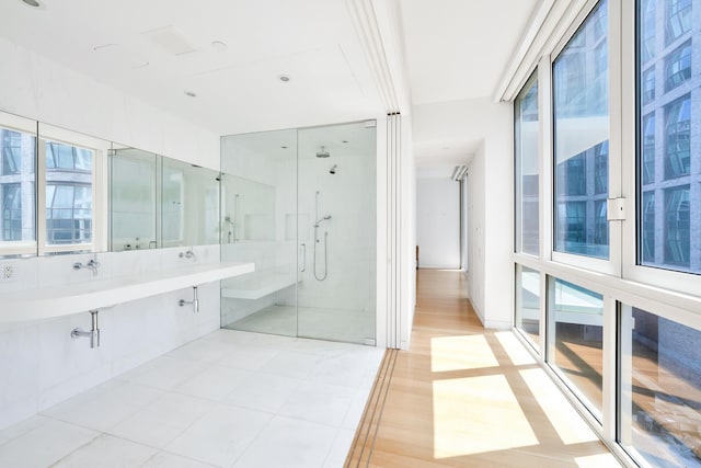 full bath featuring a stall shower, visible vents, and a wealth of natural light