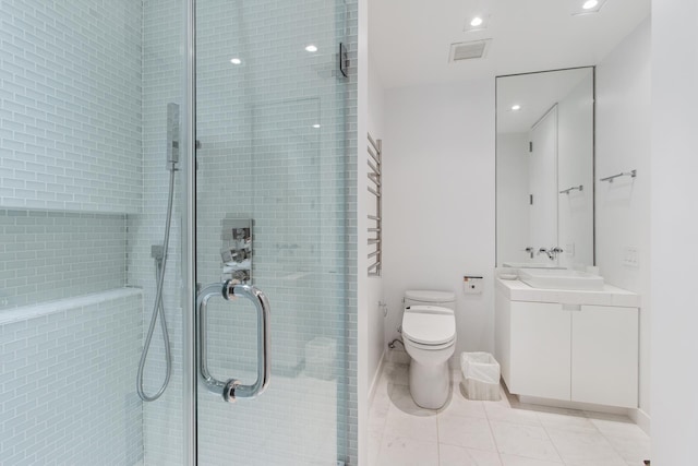 641 5th Ave Unit 27C, New York City, NY 10022 - full bathroom featuring vanity, toilet, a shower stall, tile patterned flooring, and recessed lighting