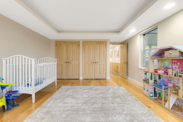 7020 108th St Unit 7E/F, New York City, NY 11375 - bedroom with two closets, a raised ceiling, wood finished floors, and baseboards