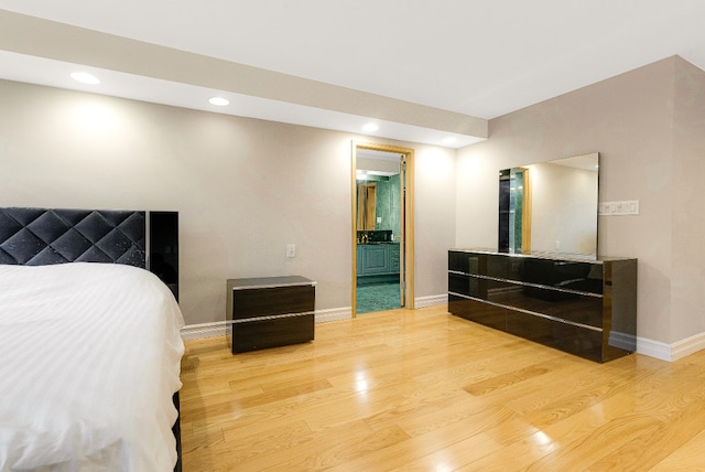 bedroom featuring wood-type flooring and connected bathroom