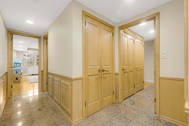 7020 108th St Unit 7E/F, New York City, NY 11375 - hall featuring a wainscoted wall, granite tiled floors, recessed lighting, and a decorative wall
