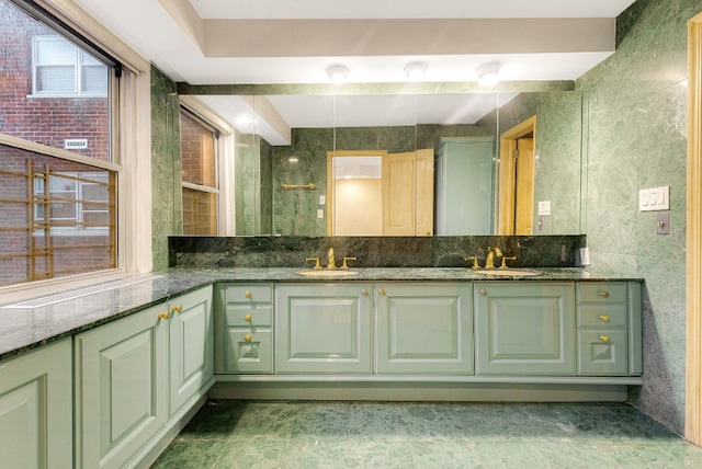 full bath featuring double vanity and a sink