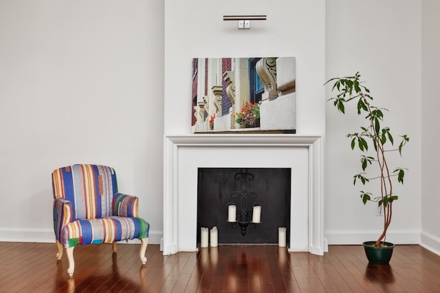 sitting room with dark wood-type flooring