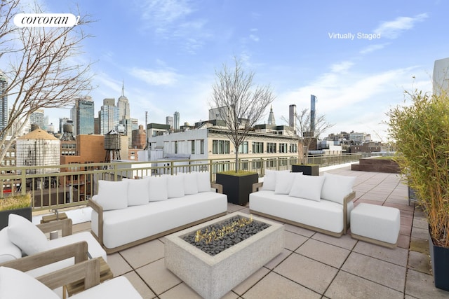 view of patio with an outdoor living space with a fire pit