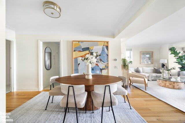 dining area featuring hardwood / wood-style floors and ornamental molding