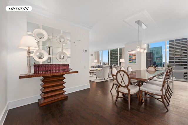 dining space featuring a chandelier, floor to ceiling windows, and hardwood / wood-style floors