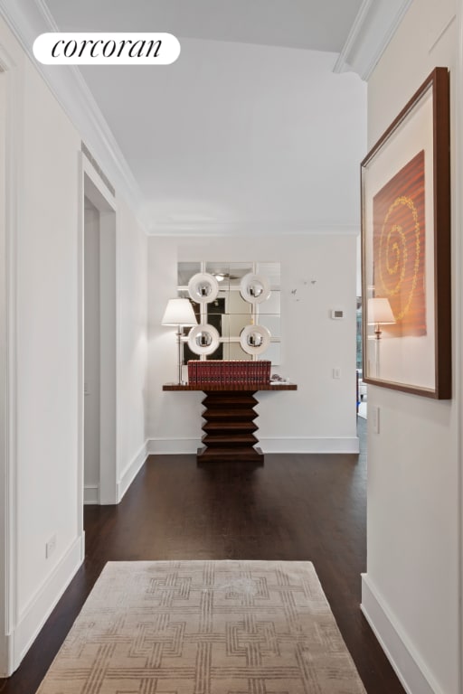 hallway featuring dark hardwood / wood-style flooring and ornamental molding