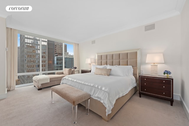 bedroom with multiple windows, crown molding, and light colored carpet