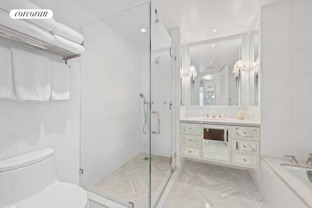 full bathroom featuring toilet, separate shower and tub, tile walls, and vanity