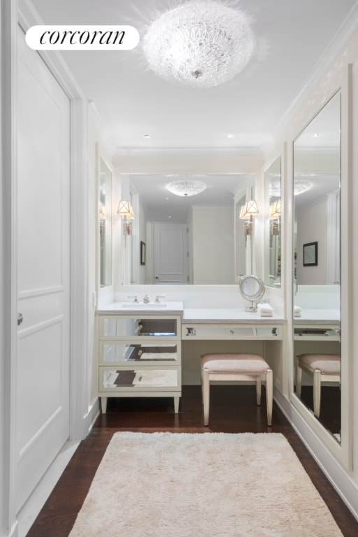 bathroom featuring ornamental molding, hardwood / wood-style flooring, and vanity