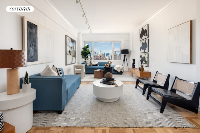 living room with rail lighting, crown molding, and parquet floors