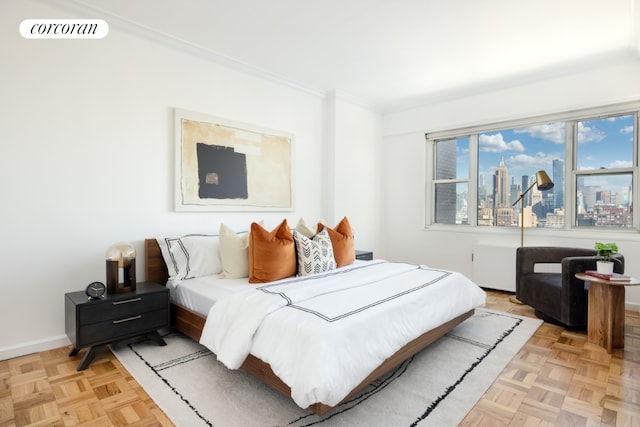 bedroom featuring light parquet flooring and ornamental molding