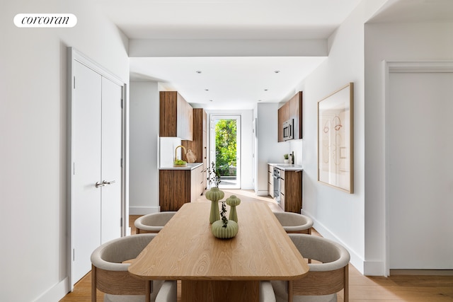 dining space featuring visible vents, baseboards, and light wood-style floors