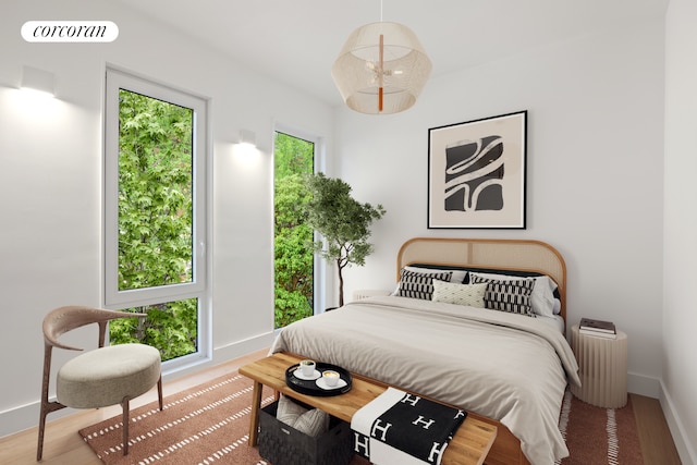 bedroom featuring visible vents, baseboards, and wood finished floors