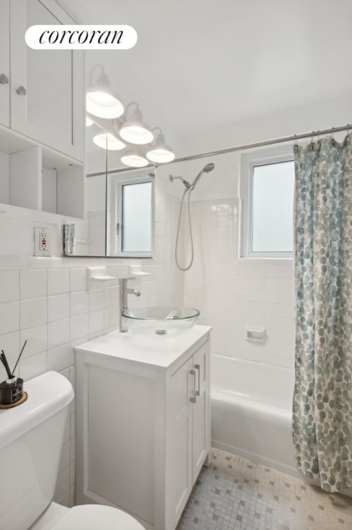 full bathroom with a healthy amount of sunlight, decorative backsplash, tile walls, and shower / tub combo with curtain